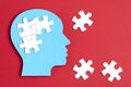 Papercut head with jigsaw puzzle pieces inside. Mental health problems, psychology, memory, logic, thinking process, solution,