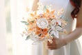 quilling chinese style chic color bouquet in the hands of a bride in a white dress