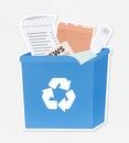 Papers in a blue recycling bin Royalty Free Stock Photo