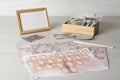 Papers with family tree, frame, photos and pencil on light wooden table Royalty Free Stock Photo