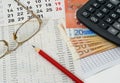 Papers with figures, calendar, glasses, red pencil, euros Royalty Free Stock Photo