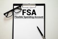 Papers with flexible spending account FSA on a table, business concept