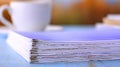 Papers Stacked Misaligned With a Clear Error Mark on the Edges of the Documents on a Blue Desk Royalty Free Stock Photo