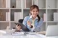 Paperwork. Happy smiling asian business woman in formal wear sitting at wooden desk in modern office and reading report Royalty Free Stock Photo