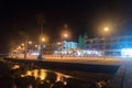 Night view on embankment and tourist walking alley along Mediterranean sea