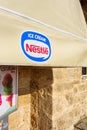 Awning of street cafe with Nestle Ice Cream logo Royalty Free Stock Photo