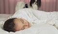 Papillon dog wakes teen girl in the bed Royalty Free Stock Photo