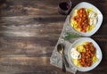 Pappardelle pasta with meat ragout with pumpkin and burrata cheese on rustic wooden background. Italian cuisine. Top view. Copy