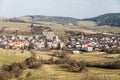 Obec Papradno s menšími kopcami Javorníkov v pozadí na Slovensku počas pekného jesenného dňa
