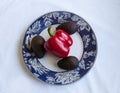 Paprika and avocadoes on a plate, white background Royalty Free Stock Photo