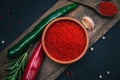 Paprika, chili peppers and rosemary on a wooden board