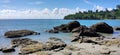 A young man is enjoying the beauty of mansinan beach, and on the left and right side there are interesting natural scenery