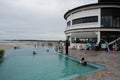 Papua, Indonesia - Oktober 20, 2021: People swimming in the pool by the beach