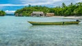 Papua Local Boat, Beautiful Blue Lagoone near Kordiris Homestay, Small Green Island and Homespay in Background, Gam