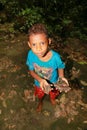 Papuan kid whowing iron artefacts from World War Two in cave Goa Jepang on Biak Island