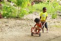 Papuan kids playing with barrow