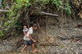 Papuan woman carrying child on her back Royalty Free Stock Photo