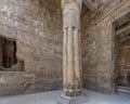 Papyrus column with a bud capital and reliefs with Egyptian hieroglyphs and gods in the Luxor Temple, Egypt.