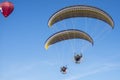 Para gliders with engine flying in the high blue sky