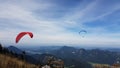 Para-gliders flying above multiple mountains Royalty Free Stock Photo