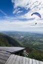Para-gliders flying in the sky, with a ramp for hang gliders and