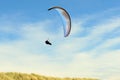 Para gliding above the dunes and coastline