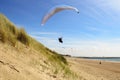 Para gliding above the dunes and coastline