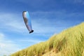 Para gliding above the dunes and coastline