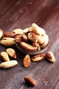 Para nuts on a rustic wooden table and para nuts in bowl Royalty Free Stock Photo