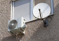 Parabolic antennas and air conditioner on the wall of an apartment building
