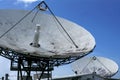 Parabolic Satellite Dish Receiver Over Blue Sky