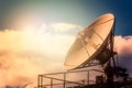 Parabolic tv antenna dish against sky with sunlight with copy sp Royalty Free Stock Photo