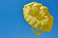 Dome of the yellow parachute on the blue sky. Royalty Free Stock Photo