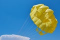 Dome of the yellow parachute on the blue sky. Royalty Free Stock Photo