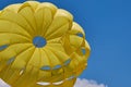 Dome of the yellow parachute on the blue sky. Royalty Free Stock Photo