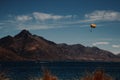 Parachute flying over water and mountains Royalty Free Stock Photo