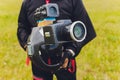 Parachute helmet with an installed DSLR camera in the hands of a skydiver, cameraman and air photographer, close-up
