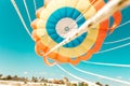Parachute parasailing of tourists on a sandy beach Sunny weather against the background of clear sea and ocean.The wind blows up Royalty Free Stock Photo