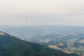 Parachute skydiver flying in clouds at top of mountains with ama