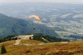 Parachute skydiver flying in clouds at top of mountains with ama