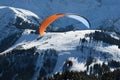 Parachuter above the snowy slope in the Alps Royalty Free Stock Photo