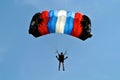 Parachuter, skydiver jumping and skydiving in parachute of black red blue white colours on parachuting cup, extreme sport