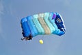 Parachuter, skydiver jumping and skydiving in parachute of blue grey colours on parachuting cup, extreme sport