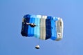Parachuter, skydiver jumping and skydiving with parachute of blue grey colours on parachuting cup, extreme sport