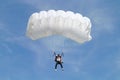 Parachuter, skydiver jumping and skydiving with white color parachute on parachuting competition, extreme sport