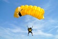 Parachuter, skydiver jumping and skydiving with yellow white black colours parachute on parachuting cup, extreme sport