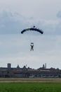 Parachutist with Blue Parachute near to the Ground Preparing for Landing Royalty Free Stock Photo