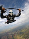 Parachutist dressed for the Helloween in free fall. Skeleton