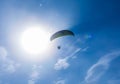 Parachutist flies against the blue sky. Motorized parachute