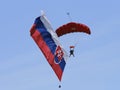 The parachutist flies with the Slovak flag behind him